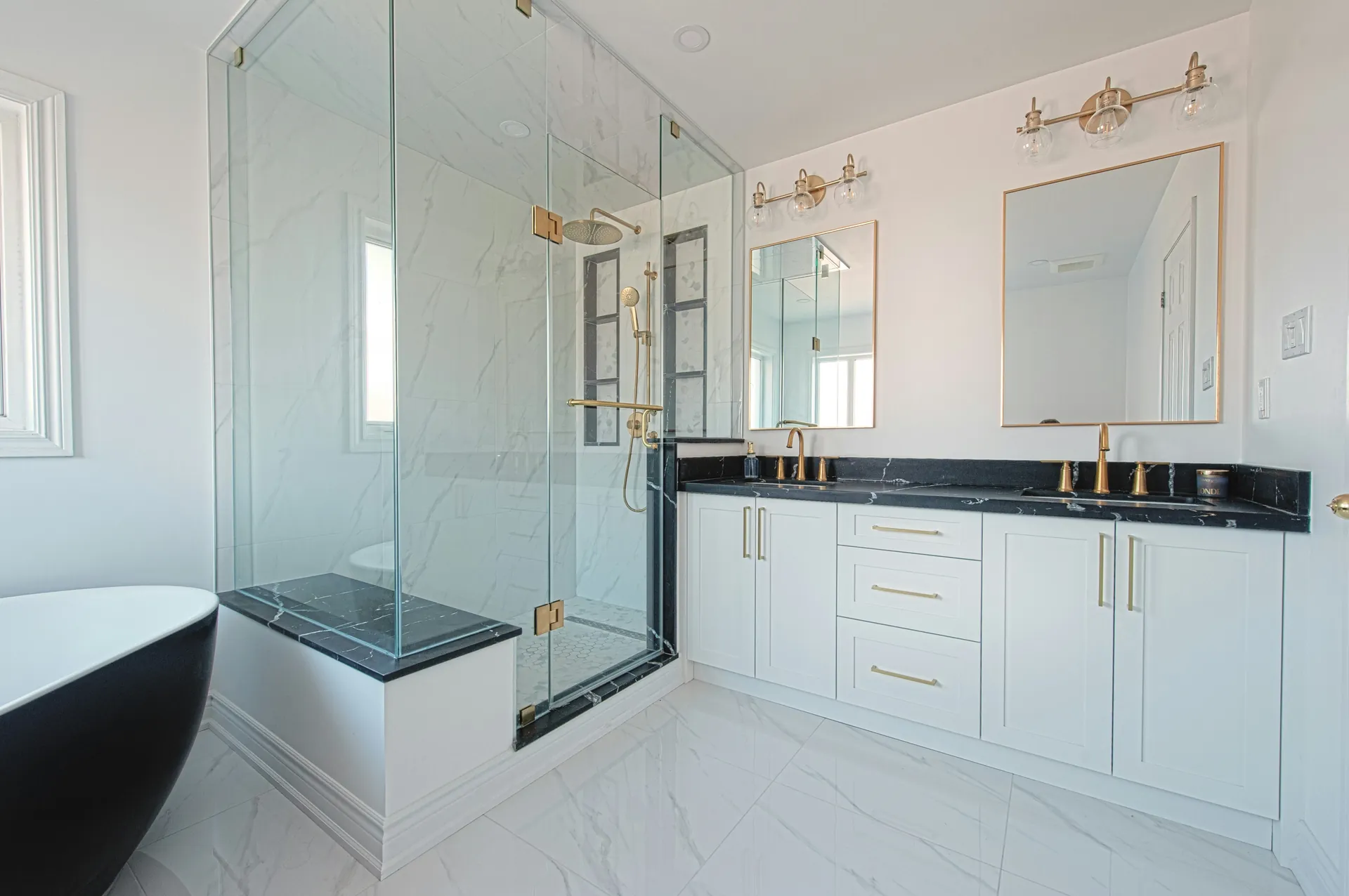 Luxury marble bathroom with glass shower and freestanding tub